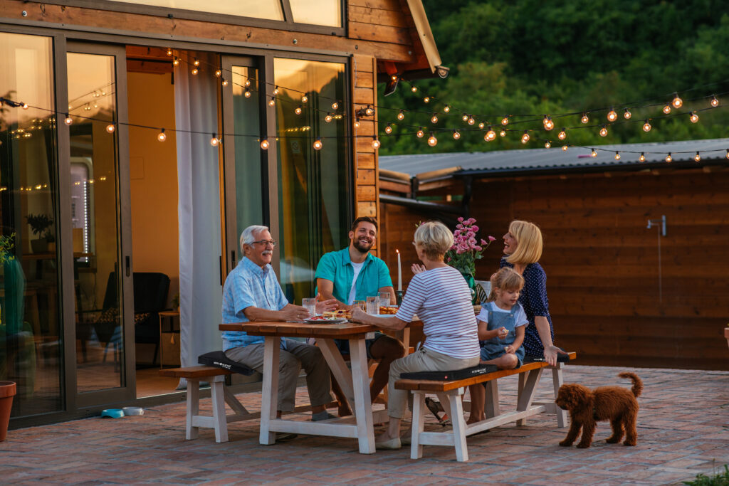 Family dinner around dining table in the garden