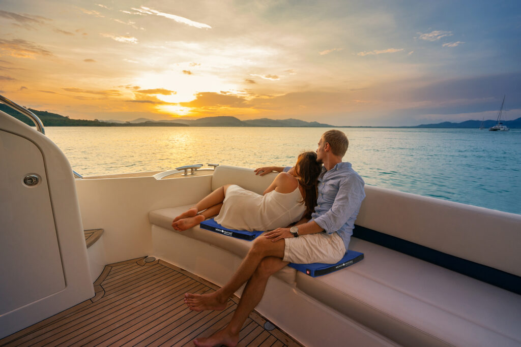 Romantic vacation . Beautiful couple looking in sunset from the